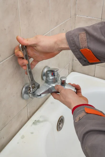 Plumber works in a bathroom Royalty Free Stock Photos