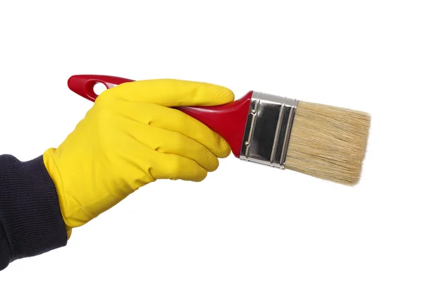 Menschliche Hand im Handschuh hält Pinsel — Stockfoto