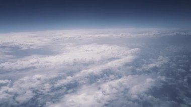 Real view of the blue sky above the clouds from an airplane