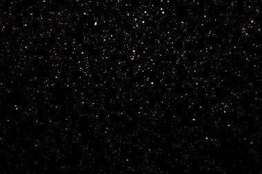 Siyah arkaplanda parlak altın parçacıklar