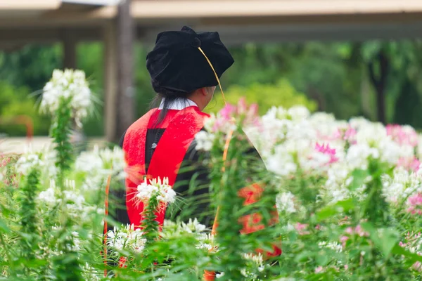 Doctor of Philosophy Graduate Elder Female Taking a Photo in the Beautiful Flower Garden