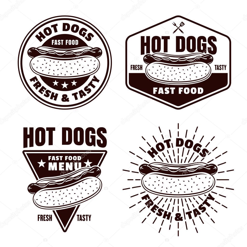 Hot dogs set of four vector monochrome emblems, badges, labels or logos in vintage style isolated on white background