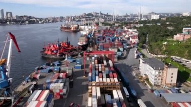 Vladivostok, Rusya, 2020 - Limandaki Vladivostok deniz konteynırı terminali operasyonu. Yukarıdan bak. Sanayi limanının genel görünümü Vladivostok 'un arka planına karşıdır. Konteyner deposu.