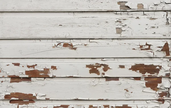 Wooden wall with white paint is severely weathered and peeling — Stock Photo, Image