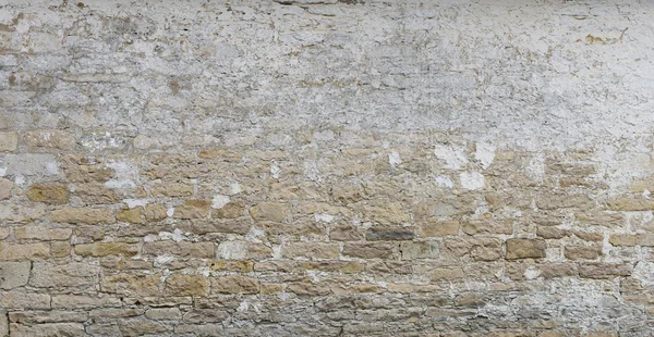 Background of old vintage  limestone wall with peeling plaster — 图库照片