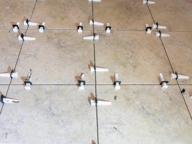 Döşeme Seviyelendirme Donları, Fayans Seviyelendirme Sistemi Plastik raptiyeler ve takozlarla.