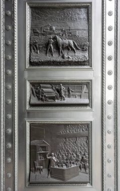 Bas Reliefs on Door, by William Bateman Fagan (1860-1948), in the city of London, UK
