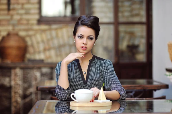 Young beautiful woman having tea-party at restaurant — Stock Photo, Image