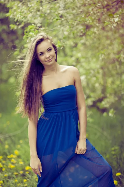 Attractive young woman in blue long dress outdoor portrait — Stock Photo, Image