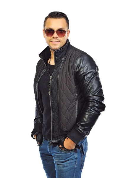 Fashion portrait of young man in jeans and black jacket posing o — Stock Photo, Image