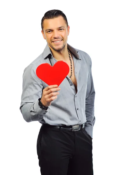 Young handsome man with heart shaped toy — Stock Photo, Image