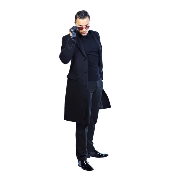 Full length portrait sexy man in black coat isolated on white — Stock Photo, Image