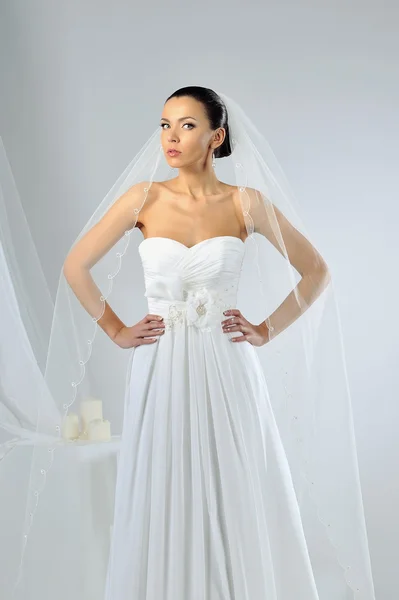 Beautiful woman in wedding dress posing in studio — Stock Photo, Image