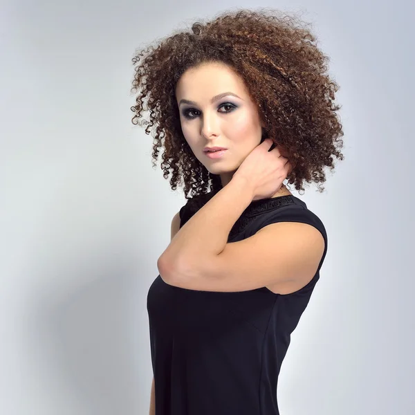 Beautiful young woman with curly hair — Stock Photo, Image