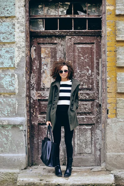 Young woman posing by an old building — Stock Photo, Image