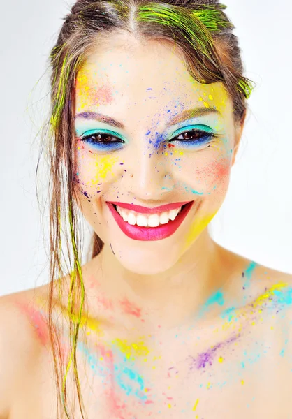 Beautiful smiling girl with colorful paint splashes on face — Stock Photo, Image