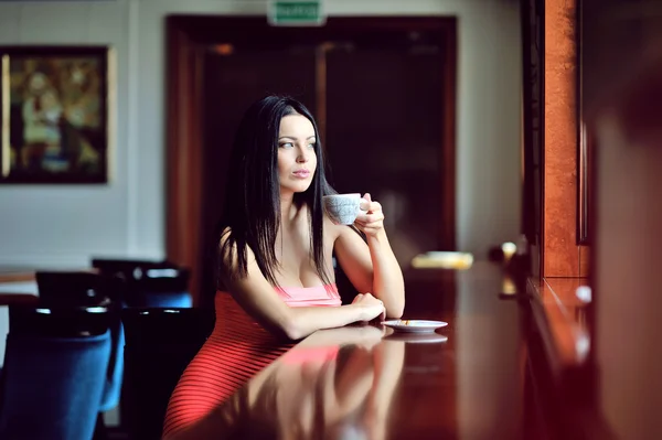 Portrait of happy brunette with mug in hands — Stock Photo, Image