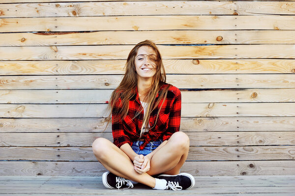 Young pretty smiling girl outdoor fashion portrait