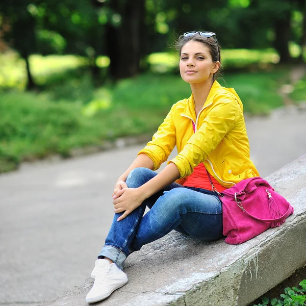 Menina elegante bonita nova com saco em um parque de verão — Fotografia de Stock