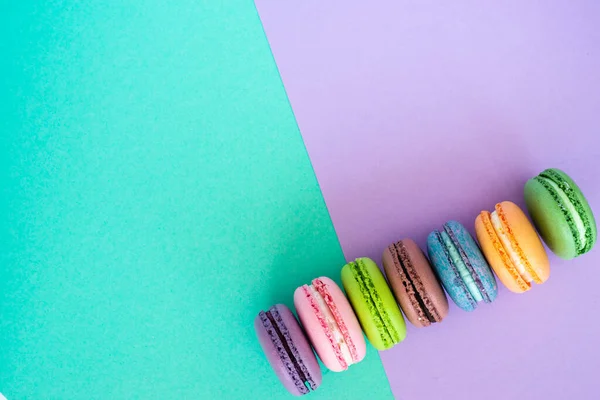 Barevné francouzské macaronů na pastelovém pozadí. Sweet concept. — Stock fotografie