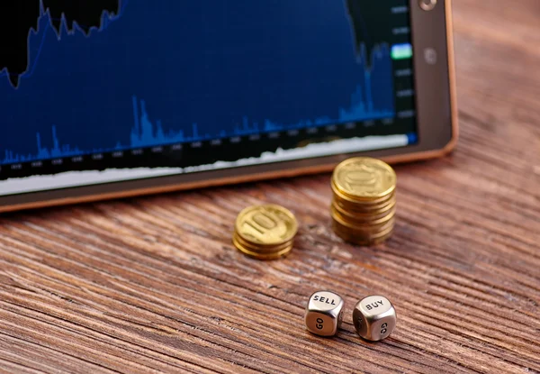 Coins, tablet, dices cubes, financial chart — Stock Photo, Image