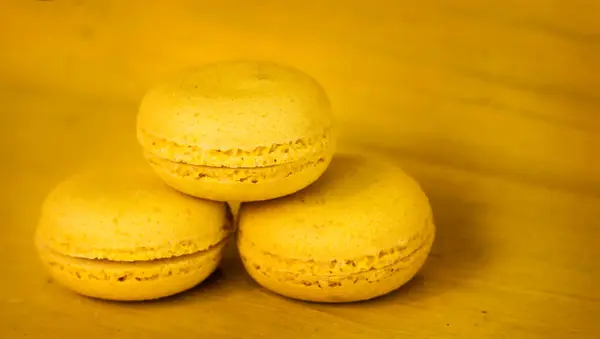 Three Yellow Delicious Almond Cookies Stacked Pyramid Yellow Wooden Background — Stock Photo, Image