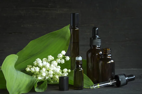 Scented Oils Lily Valley Perfumes Vials Black Wooden Background — Stock Photo, Image