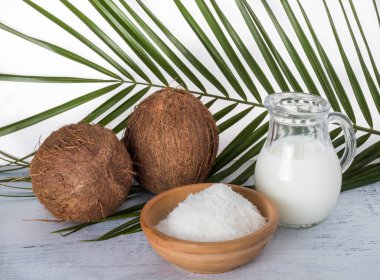 coconut milk and shavings on the background of a palm leaf.