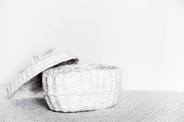 white wicker basket with lid on a white background, with a copy of the space.