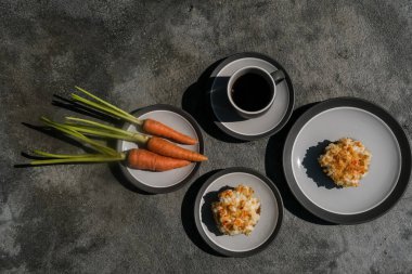 Lezzetli ev yapımı havuçlu kekler ya da malzemeli kekler ve minimalist taştan arka planda bir fincan kahve.