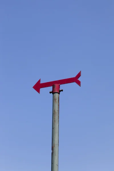 Red signpost against clear blue sky — Stock Photo, Image
