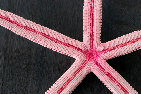 Close-up of red starfish on old wooden board — Stock Photo, Image