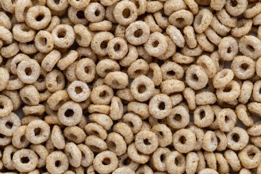 Küçük dairesel tahıl parçaları düz bir yüzeyde rastgele dizilir. Düzen, metin ya da tasarım elementlerine yer açarak dokuyu ve şekli gösterir.