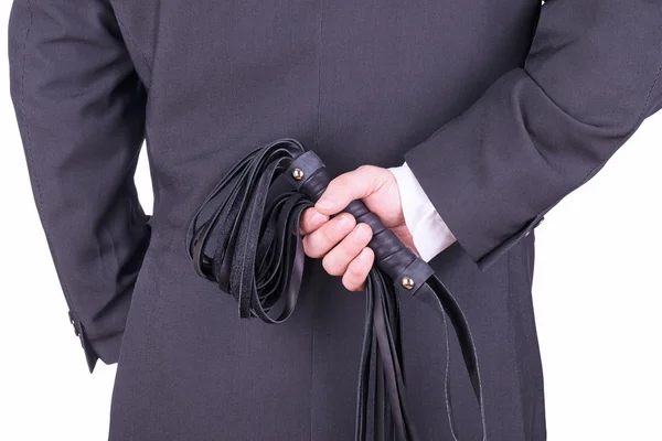 Businessman holding a leather whip. — Stock Photo, Image