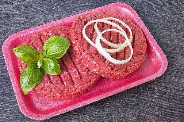 Hamburger patties, slate on background