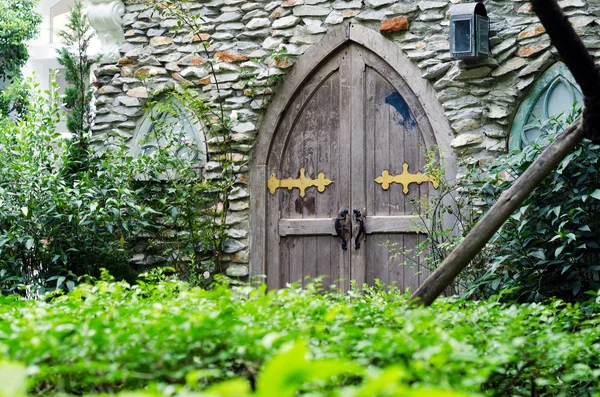 Old wooden door with stone wall — Stock Photo, Image