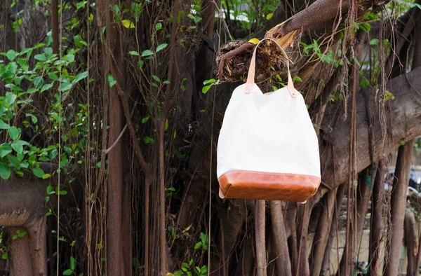 Fashion Leather Bags  hang on banyan branch — Stock Photo, Image