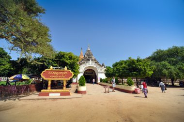 Bagan, Myanmar - October 9, 2013: Buddhist people visit Ananda temple