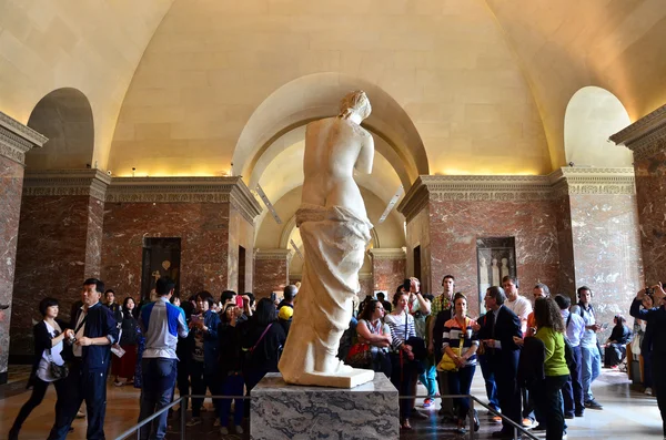 Paris, France - May 13, 2015: Tourists visit The Venus de Milo statue at the Louvre Museum