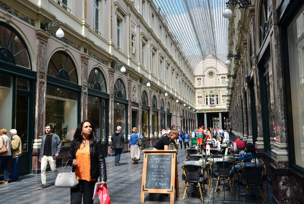 Brussels, Belgium - May 12, 2015: Tourists shopping at The Galeries Royales Saint-Hubert in Brussels