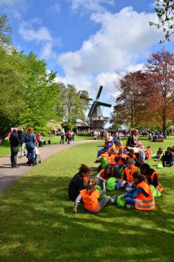 Lisse, The Netherlands - May 7, 2015: Students field trip at famous garden in Keukenhof. clipart