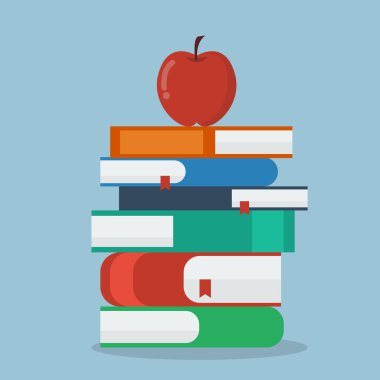 Kitap yığınının üzerinde elma