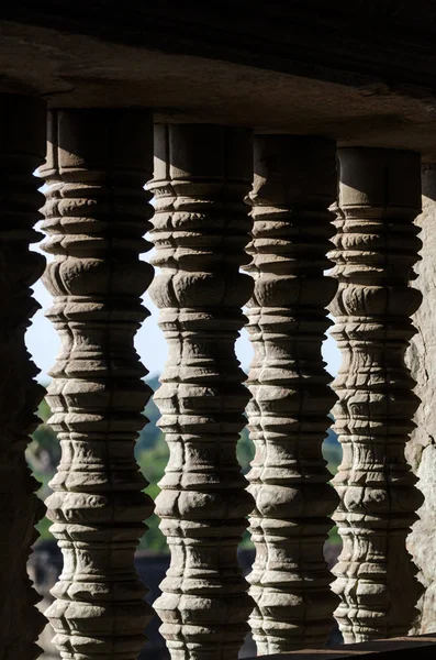 Detail of the turned stone bars of a window at the Angkor Wat in — Stock Photo, Image