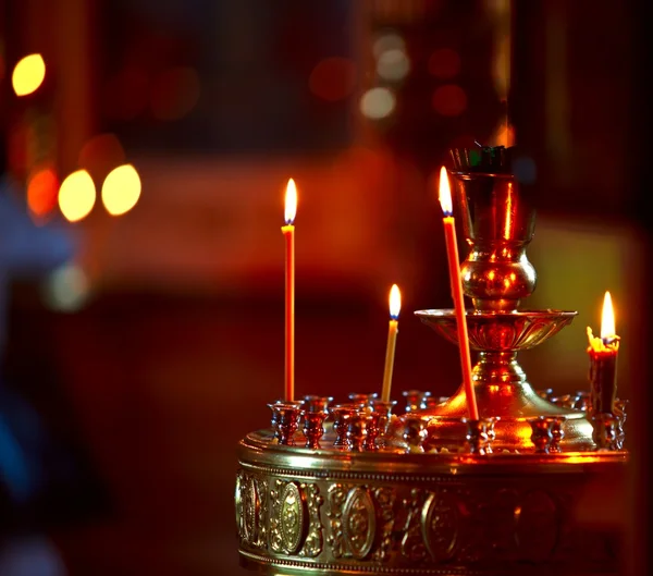 Lighting candles in a church — Stock Photo, Image