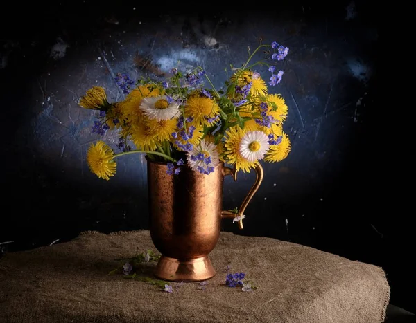 Spring composition: a bouquet of forget-me-nots and dandelions Stock Image