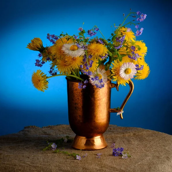 Composition printanière : un bouquet de myosotis et de pissenlits Images De Stock Libres De Droits