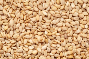 Organik Beyaz Susam Çekirdekleri 'nin (Sesamum indicum) mikro yakın plan görüntüsü veya Kabuklu Beyaz Çerçeve Arkaplanı. Üst Görünüm