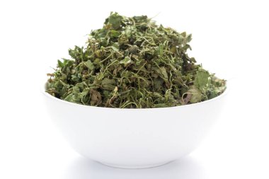 close-up of Organic green dry Fenugreek leaves (Trigonella foenum-graecum) on a ceramic white bowl. Pile of Indian Aromatic Spice clipart