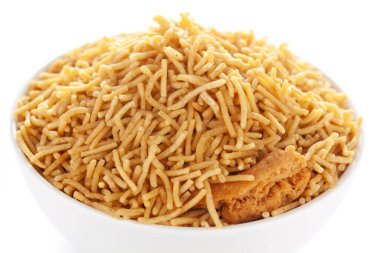 Hint baharatlı atıştırmalıkları (Namkeen) - Bikaneri Besan Bhujia beyaz bir kase içinde, nohut unundan (Besan) yapılmış, kenar manzaralı, beyaz arka planda.