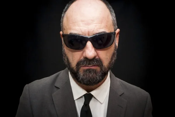 Handsome business man, bald and beard, with sunglasses over blac — Stock Photo, Image